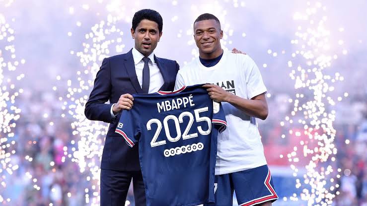 PSG president Announcing Mbappe's new contract with the player holding a jersey
