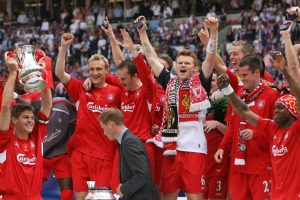 Liverpool players holding fa cup trophy 
